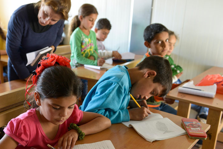 School children and teacher in a school for Syrian refugee children in Lebanon