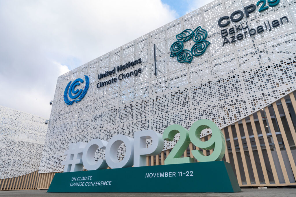 COP29 signs in front of the venue in Baku, with logo of United Nations Climate Change