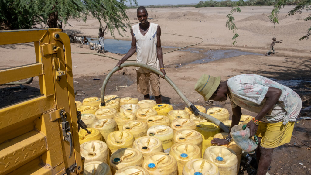 men filling up their water jerricans in Turkana County- one of the most climate-stressed regions of Kenya that faces multiple climate security risks.